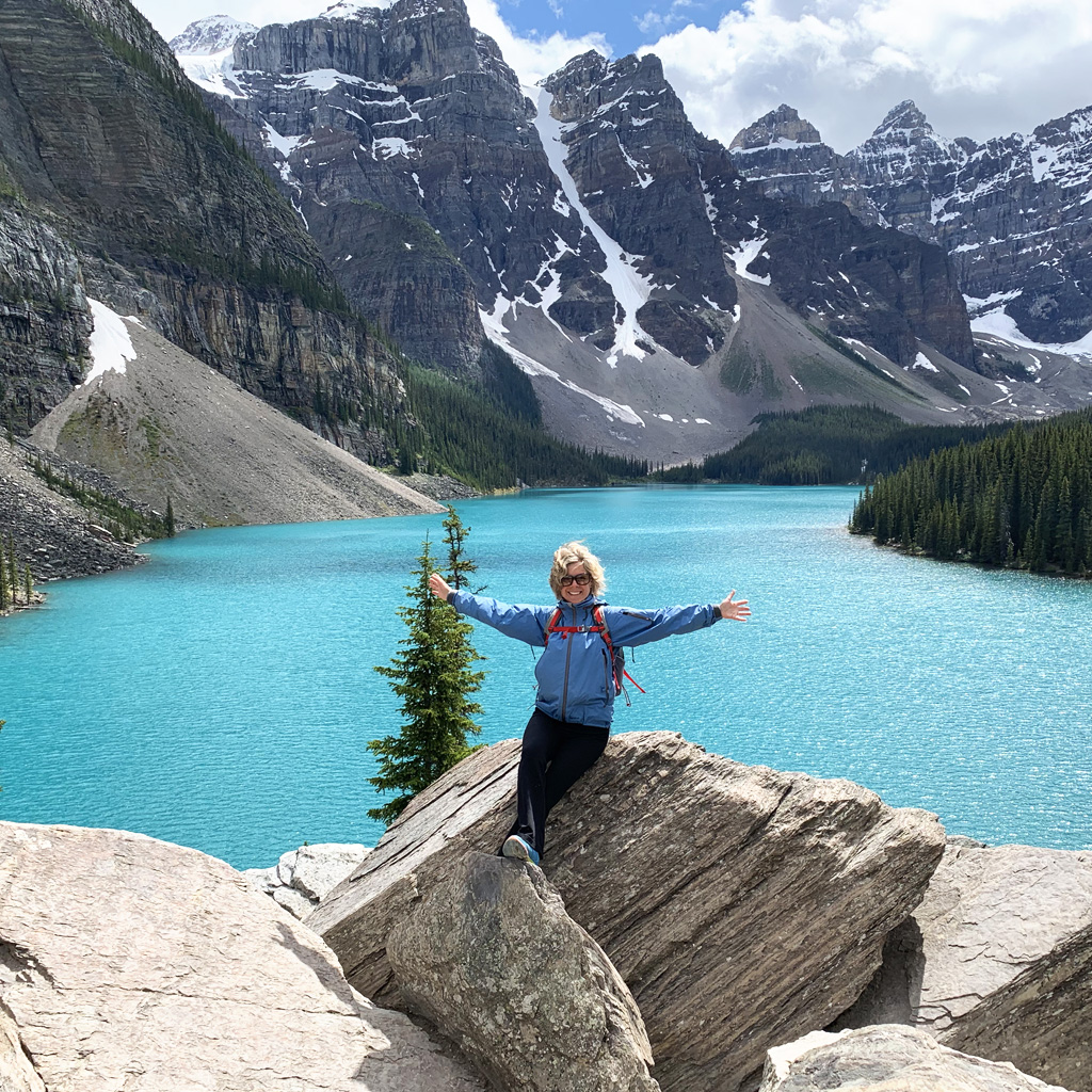 Wellness Coach Shannon Simpson posing on rocks